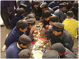 Children are having lunch with friends which they made with teamwork. Boys do not have many opportunities to prepare meals at homes. 
